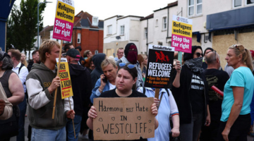 Refugees welcome signs at a rally