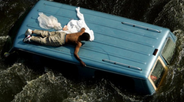 Hurricane Katrina man on car